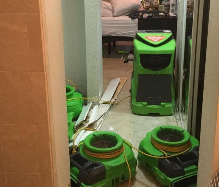 Hallway full of green air movers.