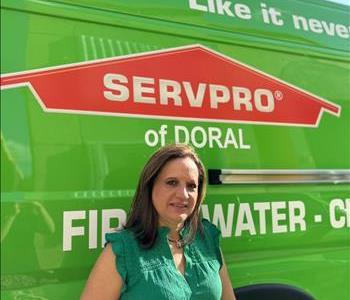 Female smiling in front of Servpro Brand