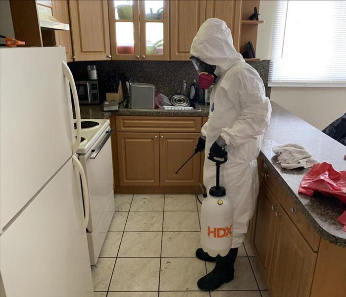 Person in PPE in a kitchen