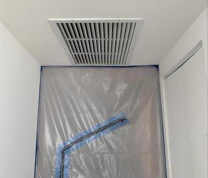 Plastic cover on a wall for mold containment purposes