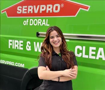Female smiling in front of Servpro Brand