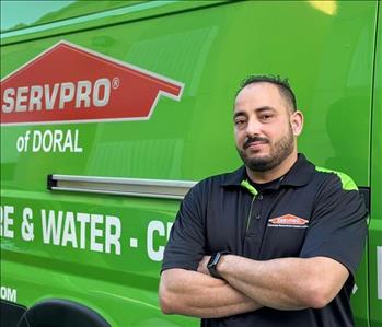 male smiling in front of Servpro Brand